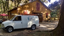 Miklos Electric's work van parked near a job site in Palm Coast, FL