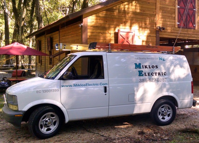 Miklos Electric's branded work van at a job site in Palm Coast, FL